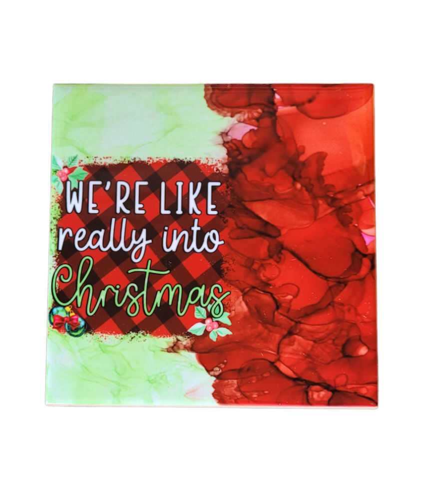 4.5 x 4.5-inch ceramic tile Christmas Coaster with red and green alcohol ink background with the words "We're like really into Christmas"