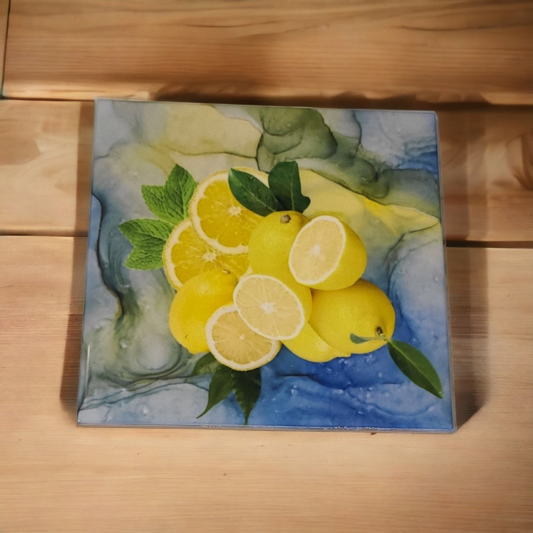 6 x 6-inch ceramic tile trivet for hot dishes with a blueish-green alcohol ink background and a picture of lemons