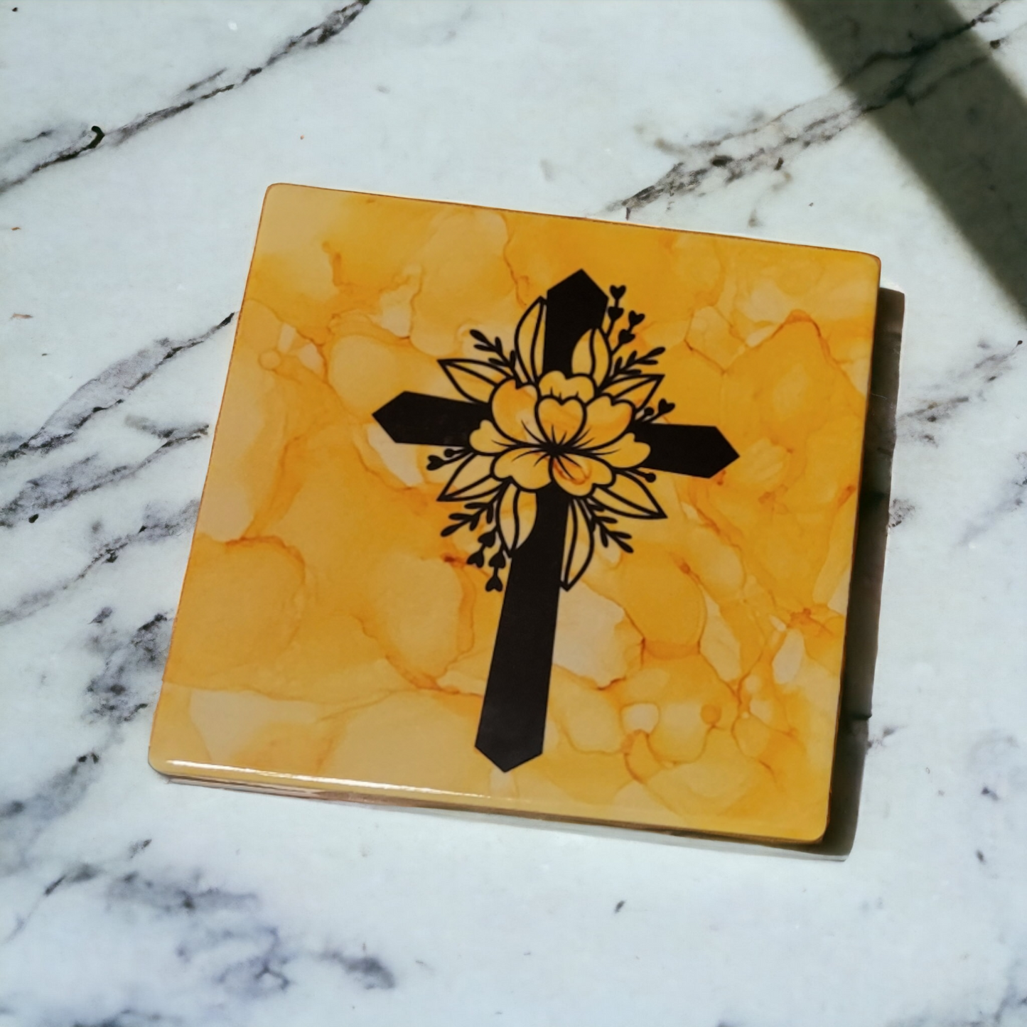 4.5 x 4.5-inch ceramic tile with a yellow alcohol ink background and a black cross.