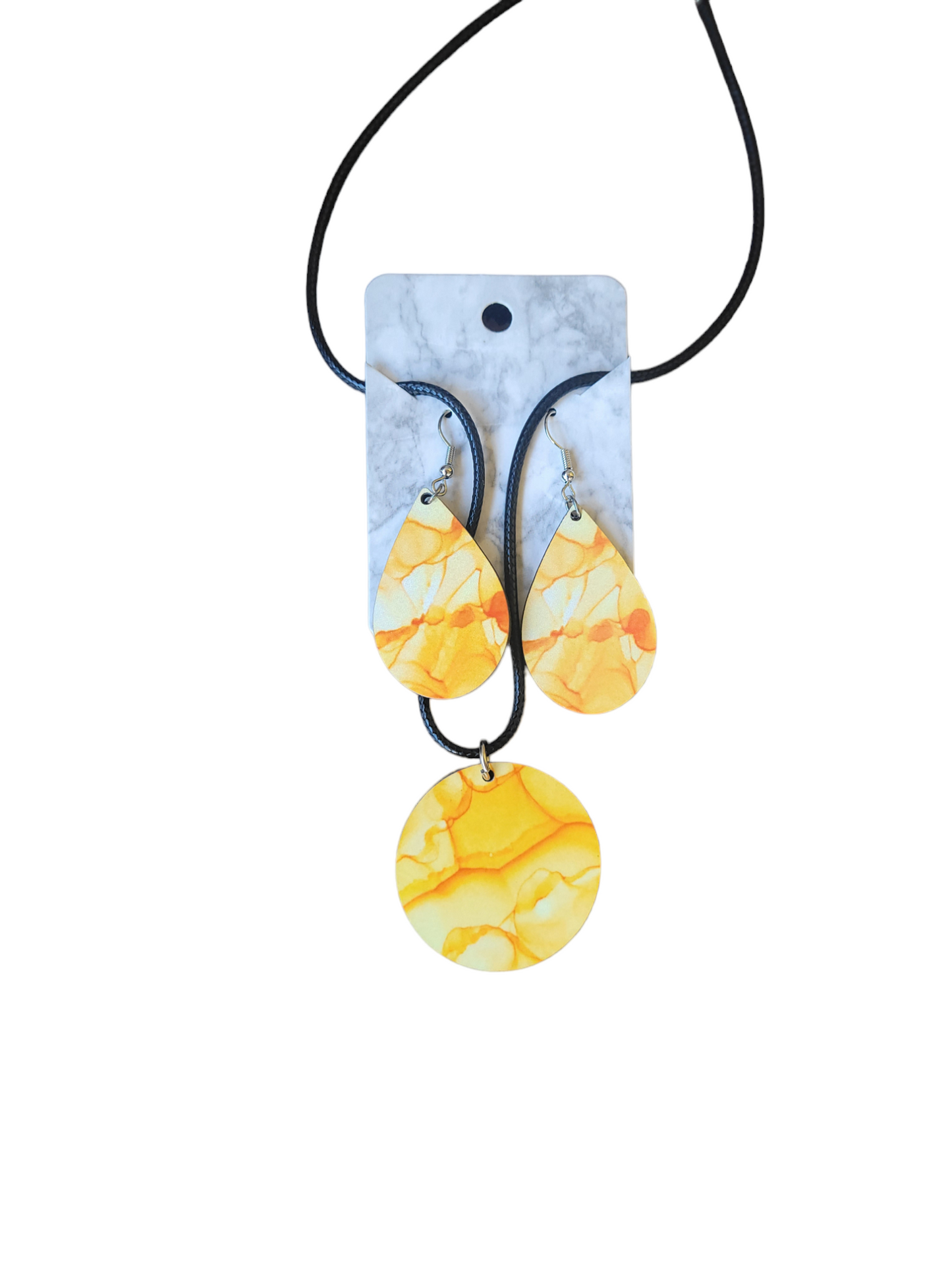 Circle shaped necklace and teardrop earrings yellow in color