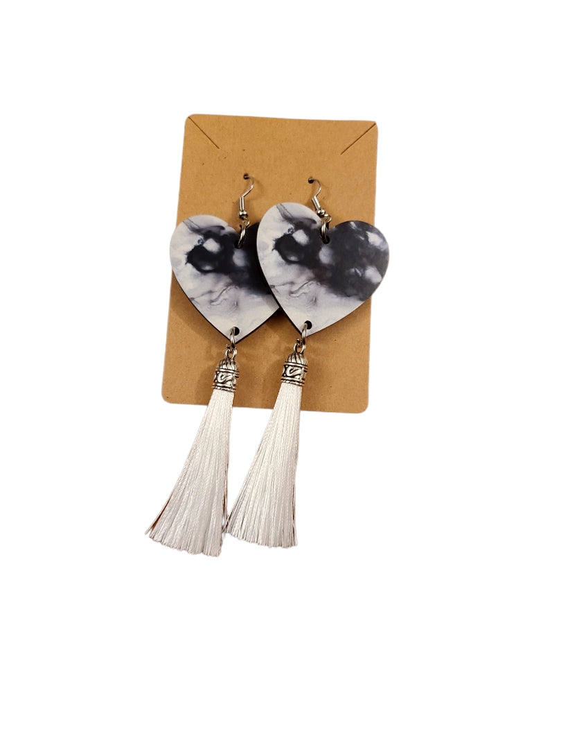 Dye-sublimation alcohol ink heart shaped earrings that are black and white with white tassels